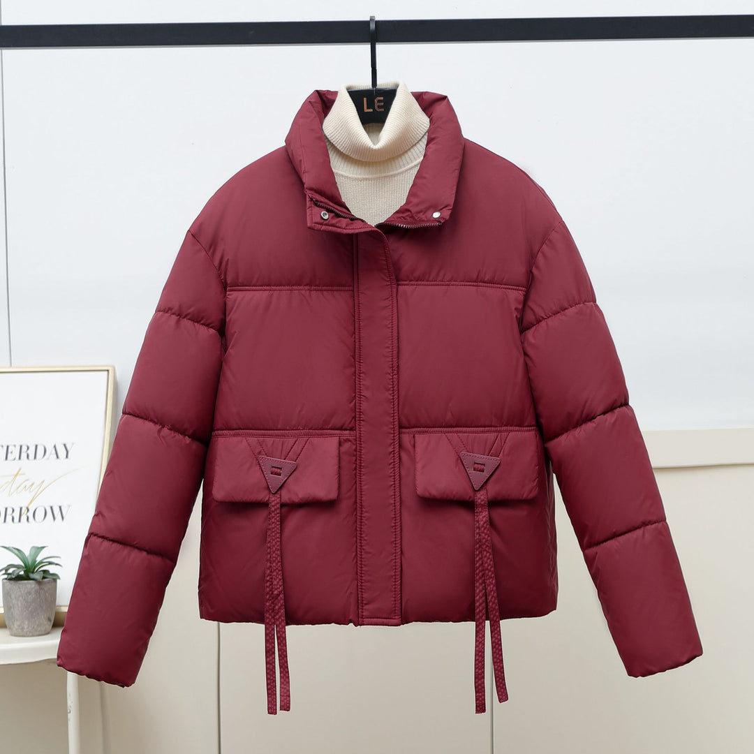 Quilted transitional jacket for women with high collar and practical modern pockets Lune London