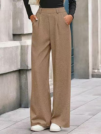 Loose fabric trousers for women with high waist and practical pockets. Chic and style