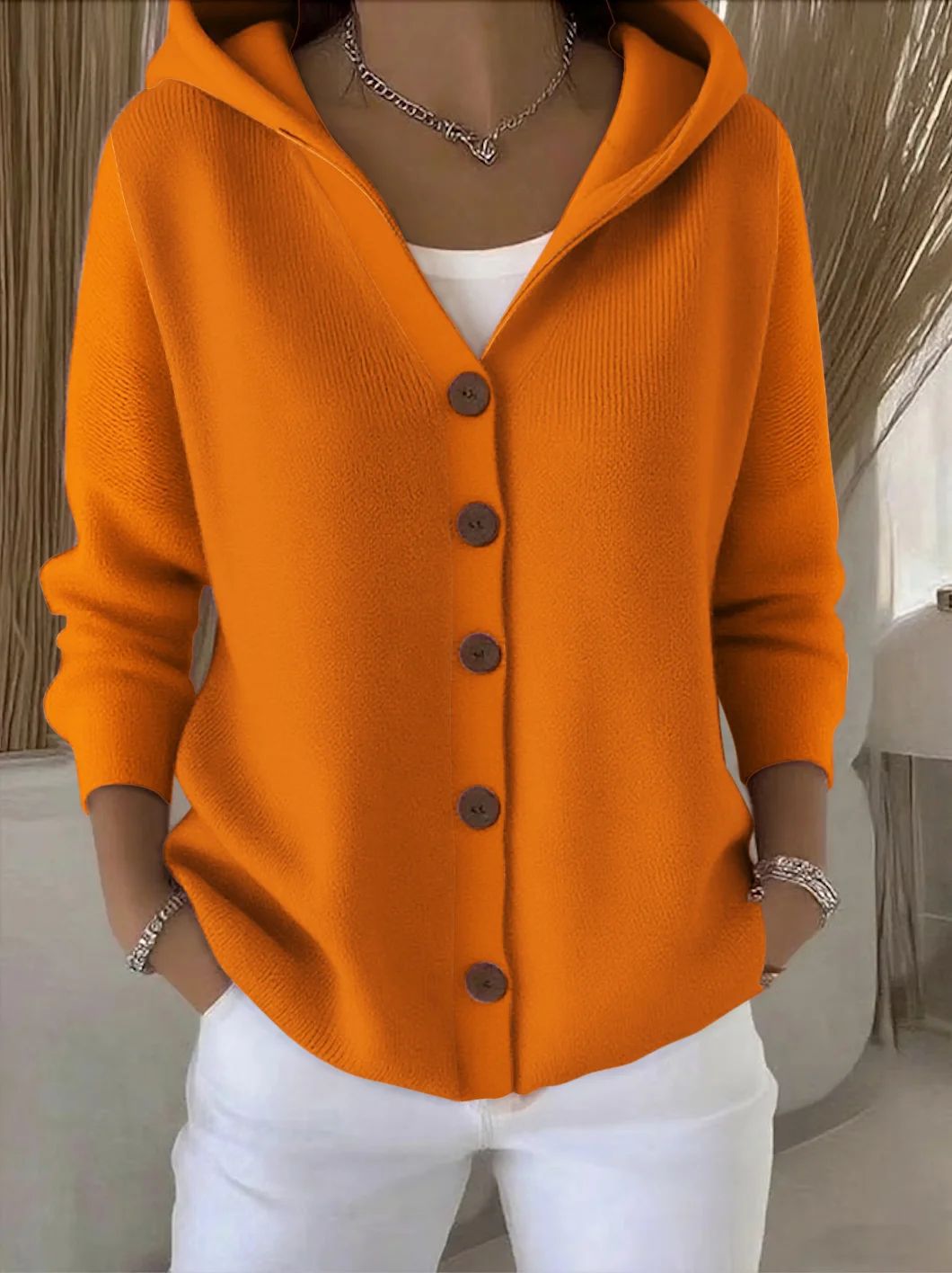 Knitted hooded jacket for ladies with practical button details and a relaxed fit Lune London