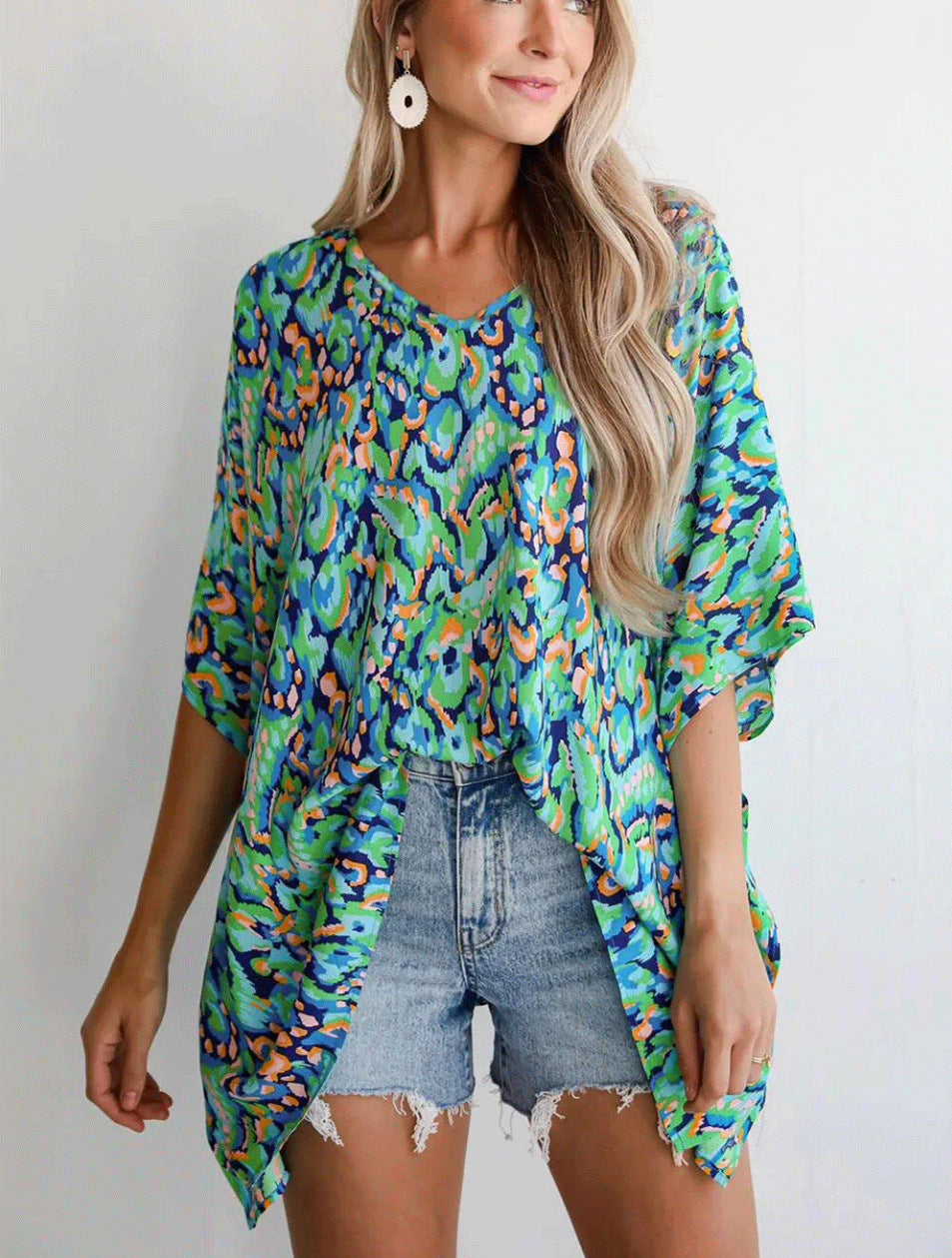 Casual beach blouse for women with an asymmetrical cut and colorful pattern Lune London