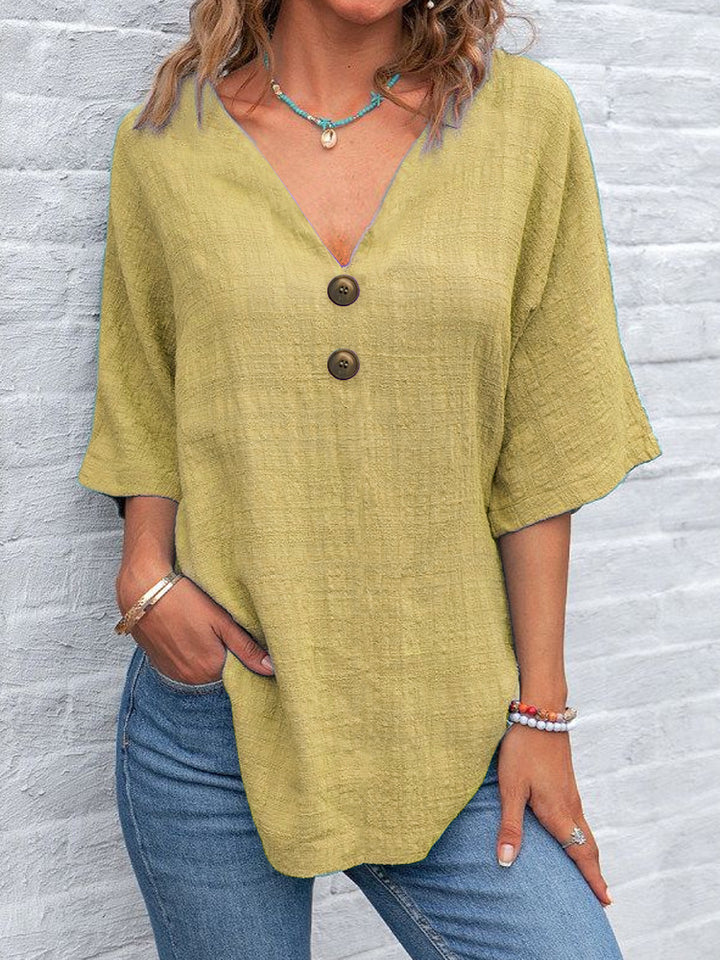 Ladies' V-neck blouse with decorative buttons and chic casual cut