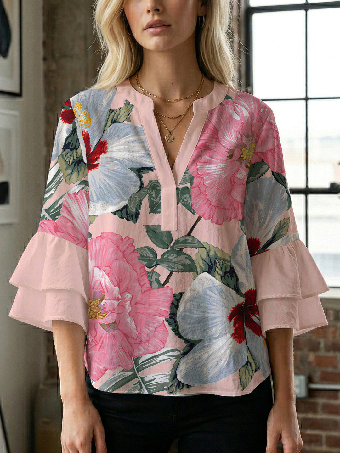 Women’s blouse with voluminous ruffled sleeves and floral pattern Lune London