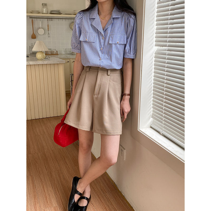 Women's short sleeve blouse with subtle striped pattern and decorative button details Chic & Stil