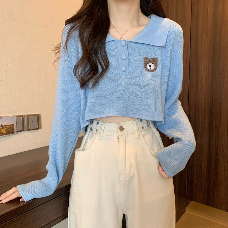 Women Cropped Pullover with a one-button closure and unicorn emblem