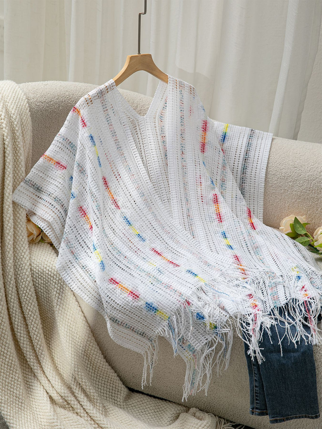 Ladies casual poncho with fringe details and a chic and stylish colorful pattern