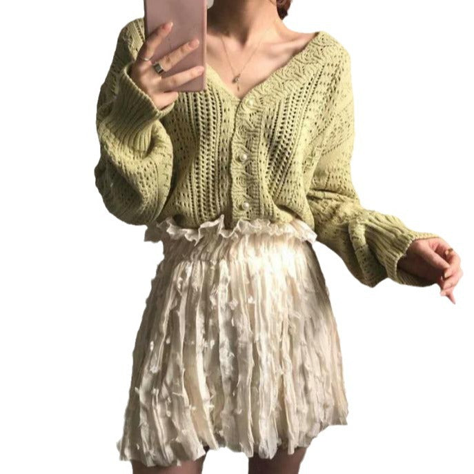 Thick knitted sweater for women with a trendy V-neck and chic button details