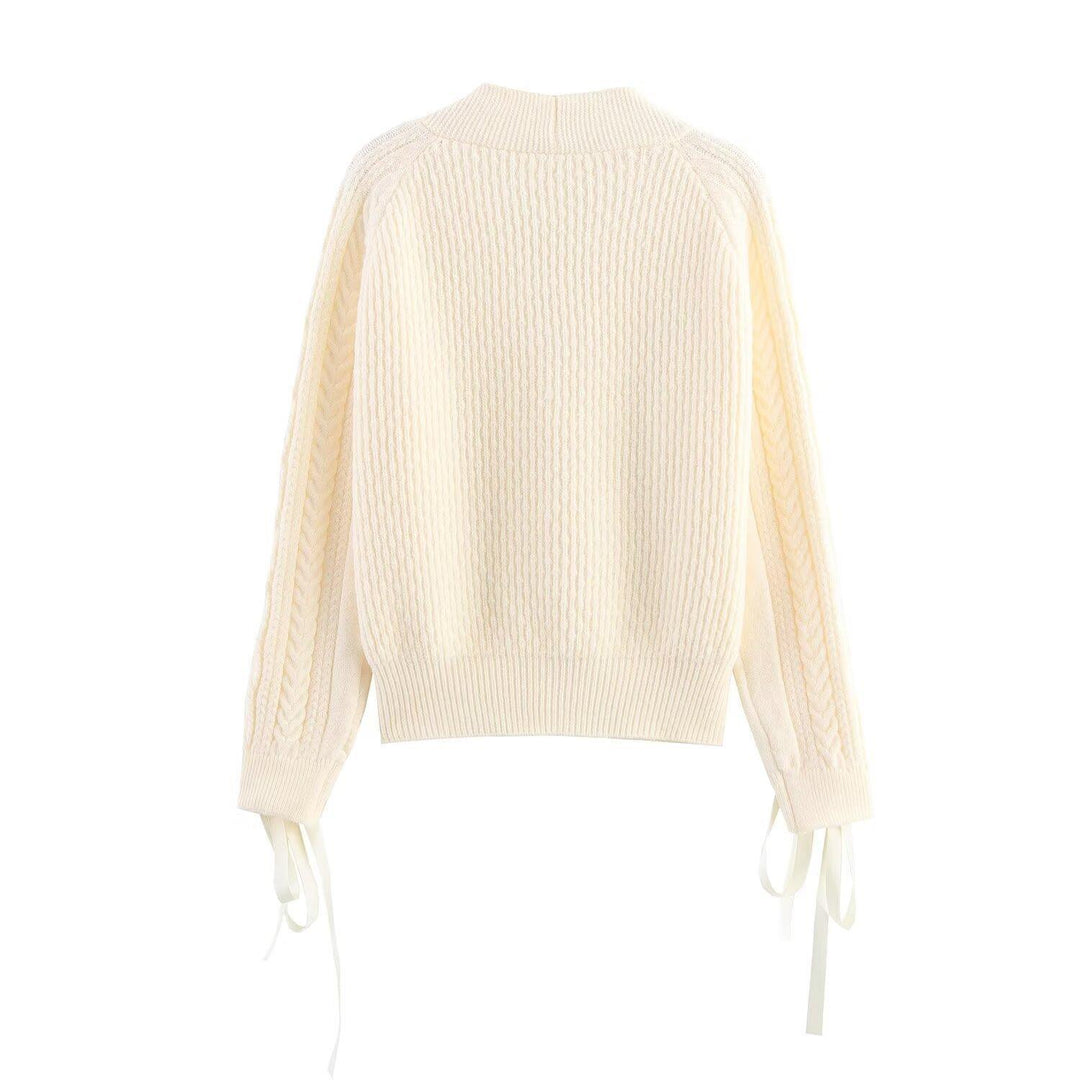 Elegant women's cardigan with decorative buttons and ruffle details Lune London