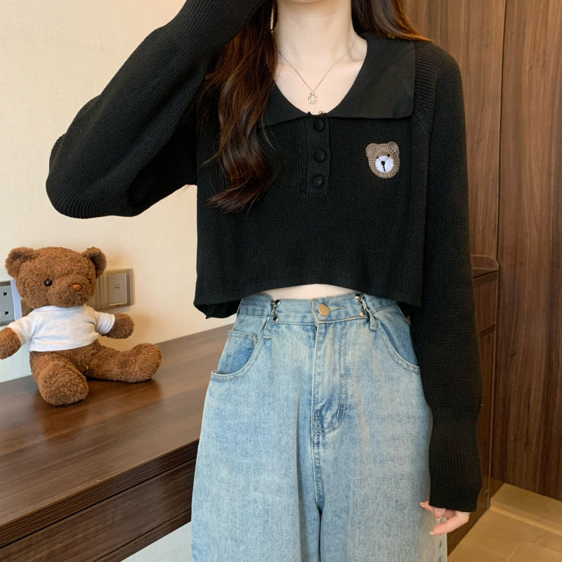 Women Cropped Pullover with a one-button closure and unicorn emblem