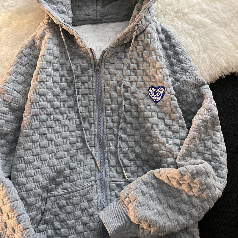 Women's hoodie jacket made of structured material with practical pockets and fashionable design