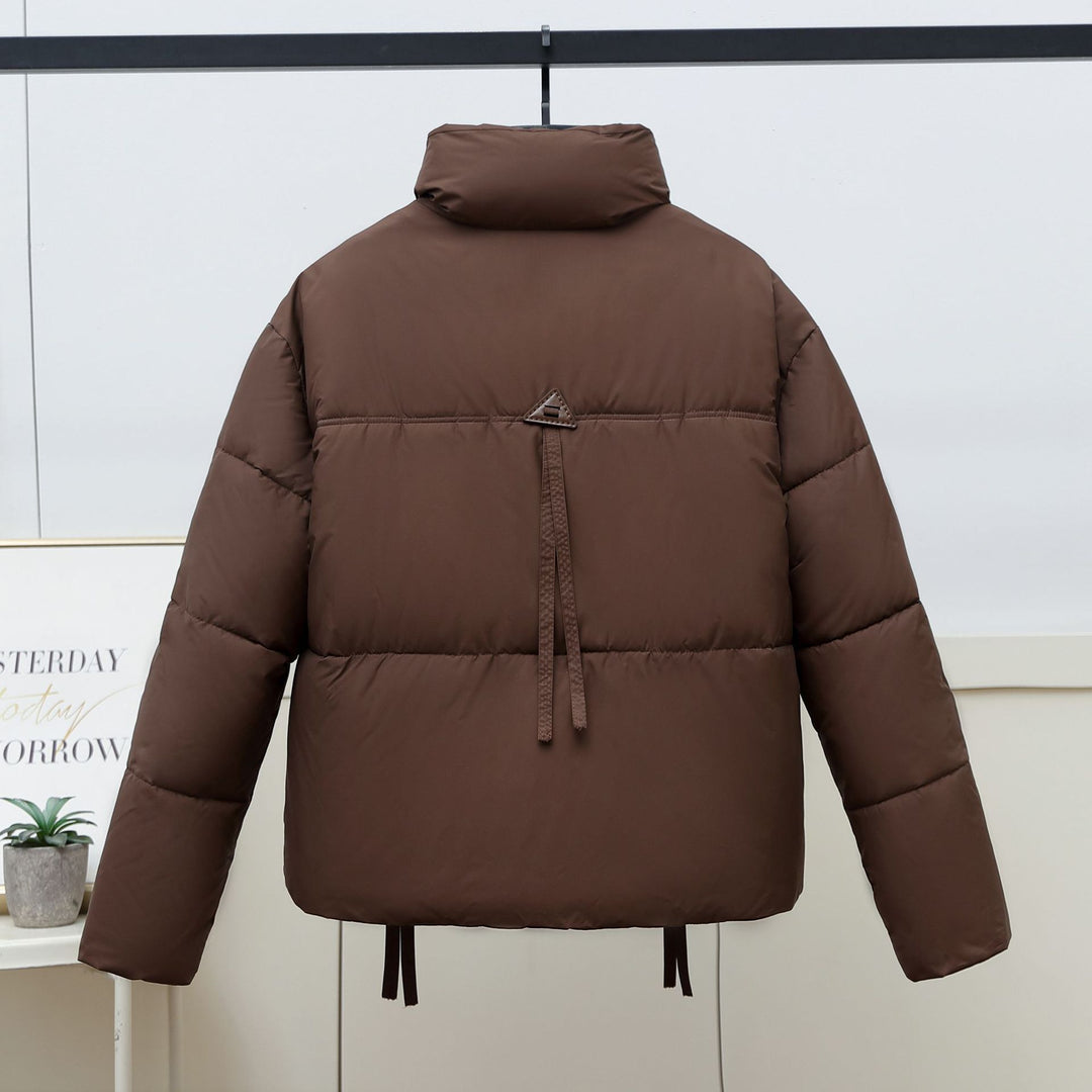 Quilted transitional jacket for women with high collar and practical modern pockets Lune London