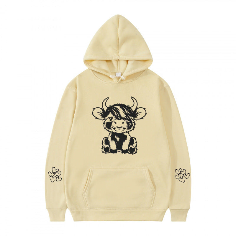 Women's hooded sweatshirt with charming cow motif and practical kangaroo pockets Lune London