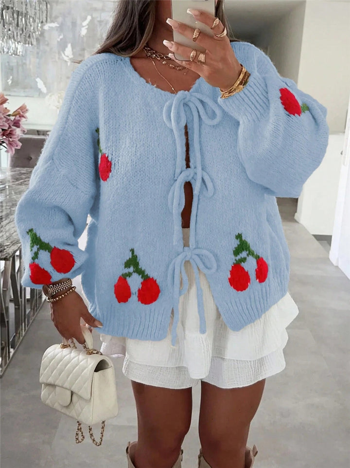Women's knitted jacket with playful cherry pattern and decorative bows Lune London