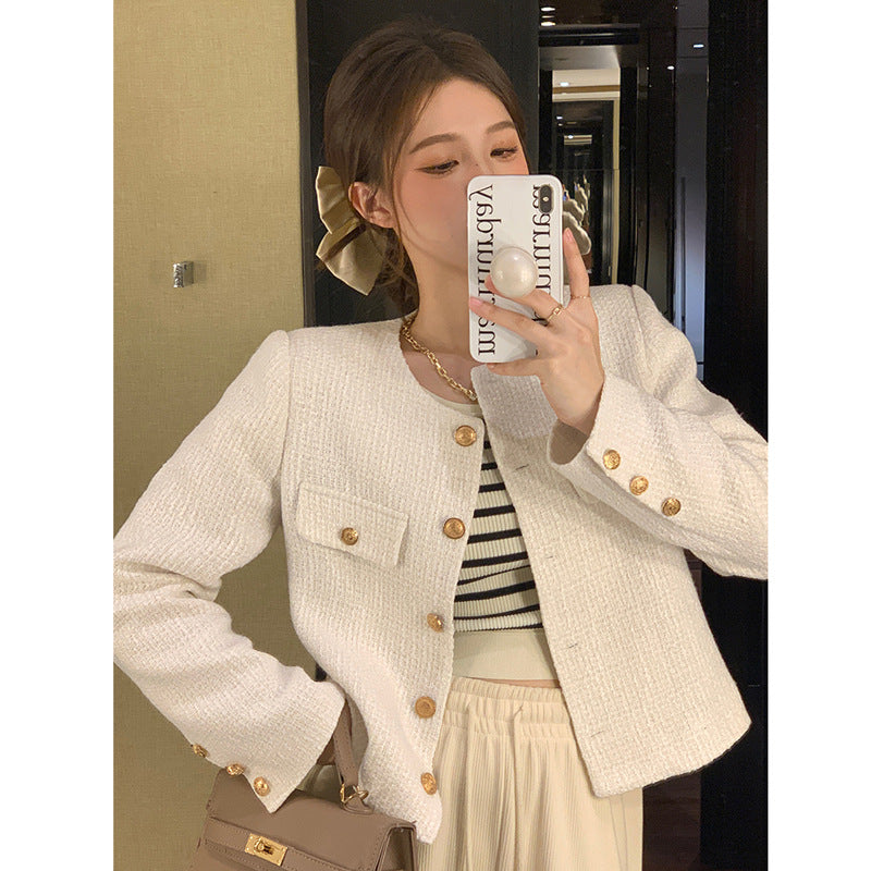 Women's short blazer with elegant gold buttons and modern cut