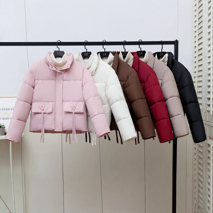Quilted transitional jacket for women with high collar and practical modern pockets Lune London