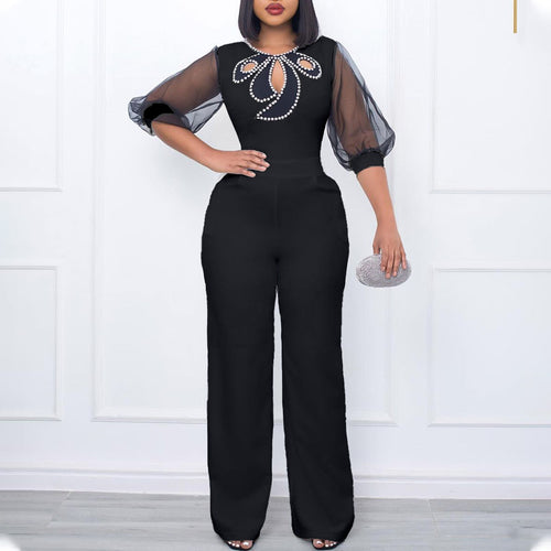 Elegant woman’s jumpsuit with sheer sleeves and pearl embellishment Lune London