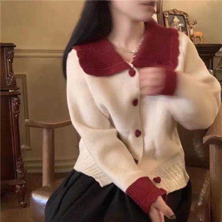 Knitted women's jacket with heart-shaped buttons and a distinctive ruffle collar Lune London