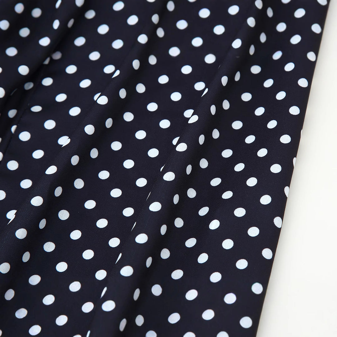 Midi dress for women with thin spaghetti straps and a playful polka dot design Lune London