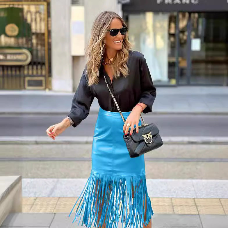 Women's fuchsia fringe skirt made of faux leather with a fitted silhouette and swinging design