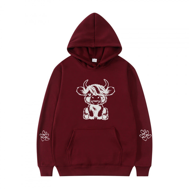 Women's hooded sweatshirt with charming cow motif and practical kangaroo pockets Lune London