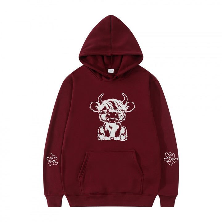 Women's hooded sweatshirt with charming cow motif and practical kangaroo pockets Lune London