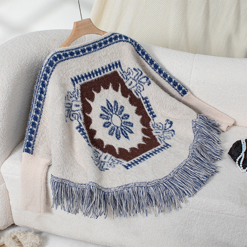 Ladies elegant knitted poncho with artistic pattern and fringe finish Lune London