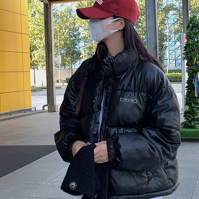 Trendy winter jacket for women with a high collar and zippered side pockets.