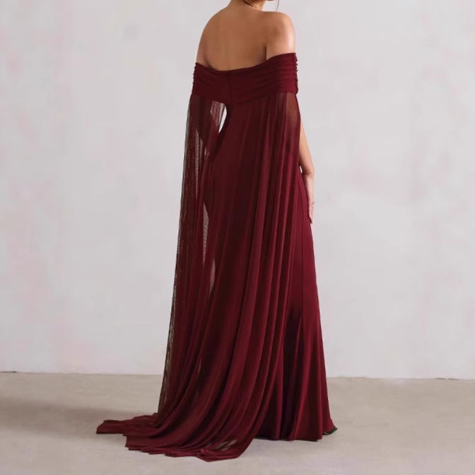 Elegant evening dress for women with off-the-shoulder design, flowing sheer cape, and flattering cut Lune London