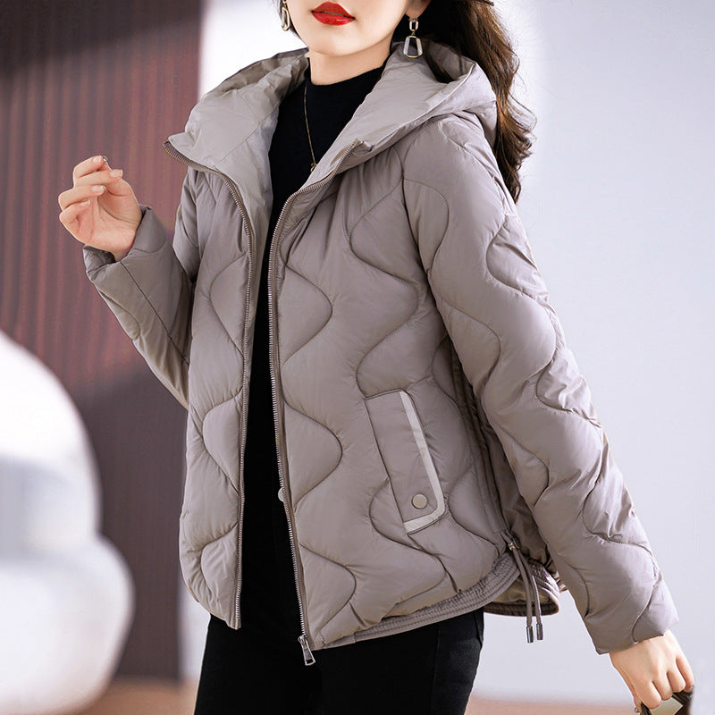 Insulated quilted jacket for women with high collar and practical zip pockets Lune London