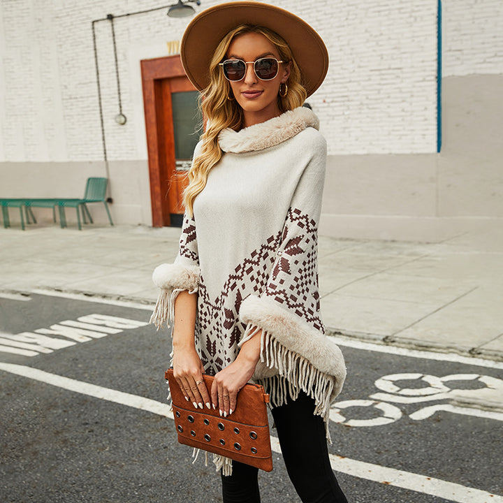 Elegant women's poncho with decorative fringe design and faux fur trim Lune London