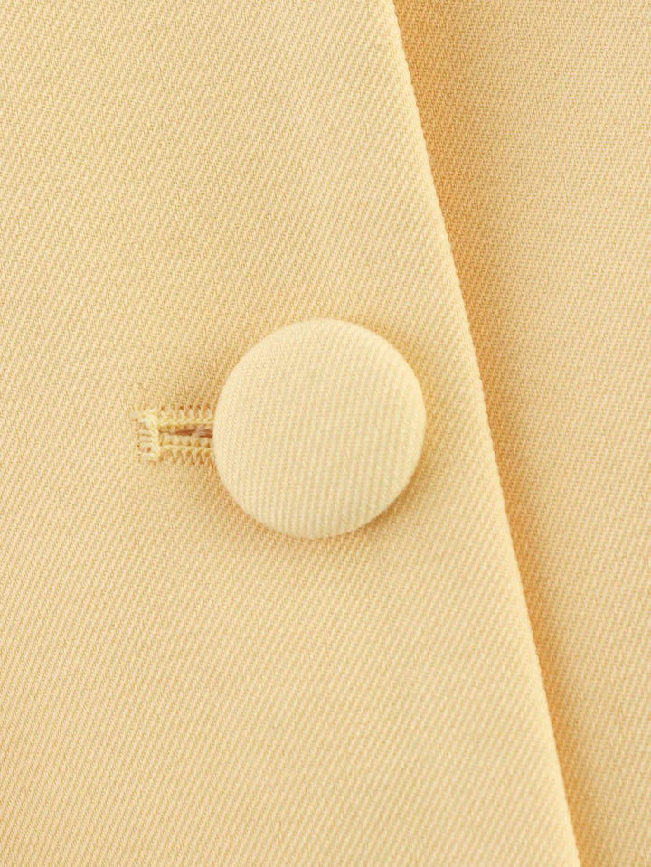 Elegant short blazer for women with a tailored fit and chic button details.