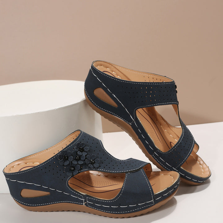 Comfortable wedge sole sandals for women with an airy surface structure and elastic straps Lune London