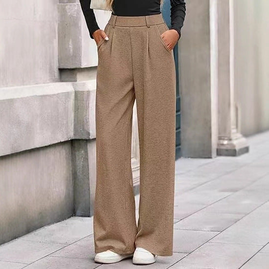 Loose fabric trousers for women with high waist and practical pockets. Chic and style