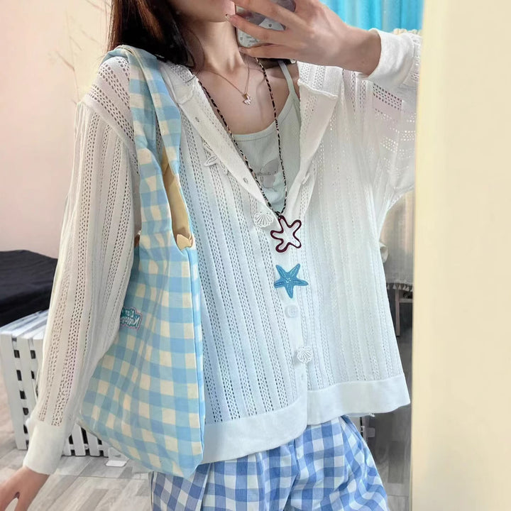 Knitted jacket for women with an airy lace pattern and practical pockets Lune London
