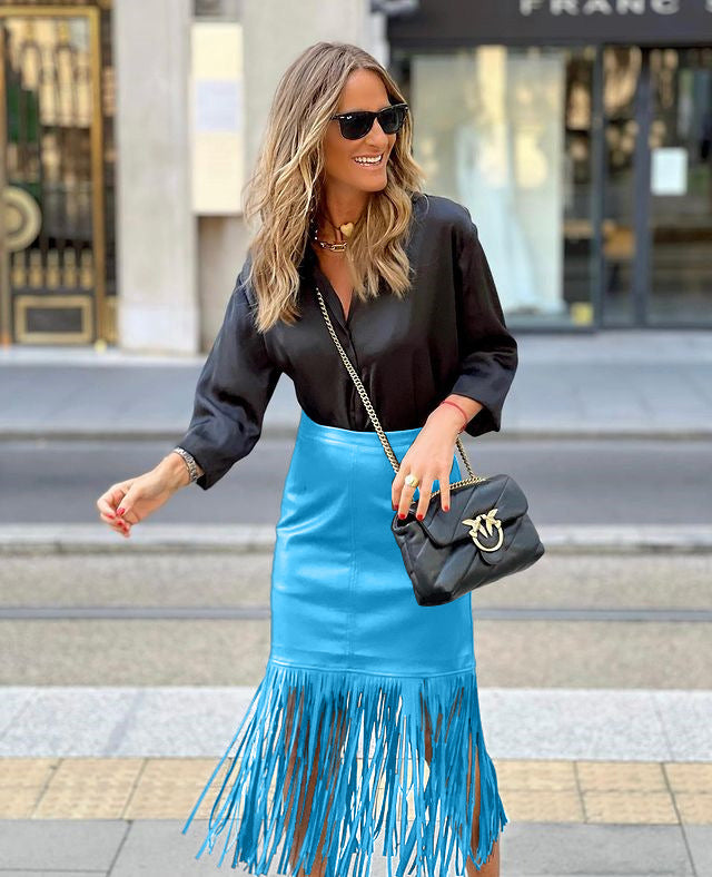 Women's fuchsia fringe skirt made of faux leather with a fitted silhouette and swinging design